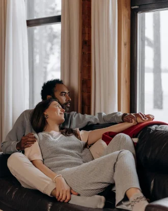 Couple sitting close during a therapy session, symbolizing connection and growth.