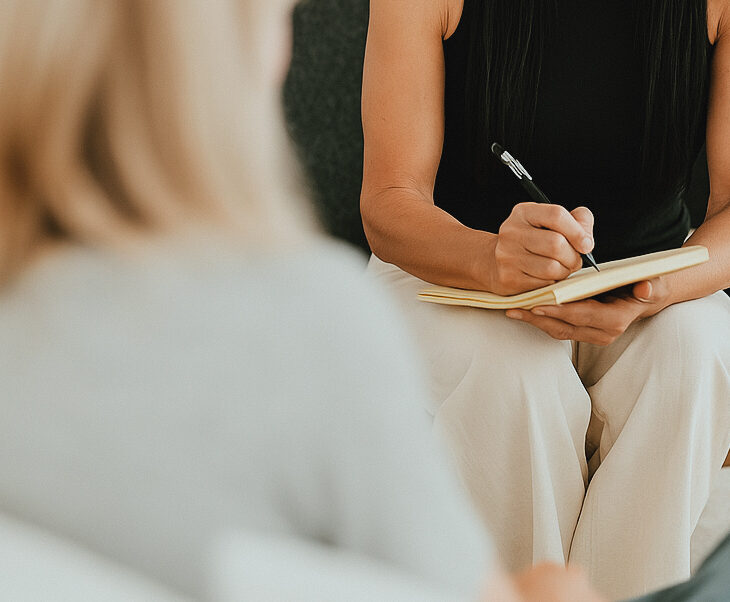 Client in discussion with a therapist, representing personalized emotional support."